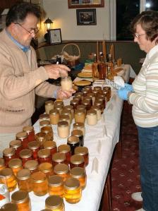 Ricky judging honey with Joyce as steward